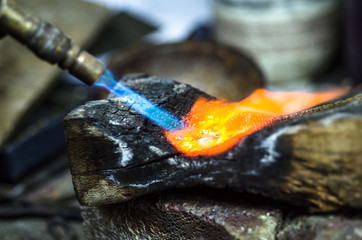Close-up of jewelry welding with blowtorch.