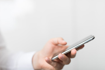 hand holding mobile phone isolated on white