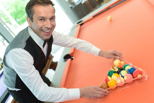 businessman holding billiard balls