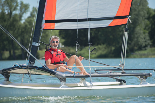 mature man enjoying sailing on a lake
