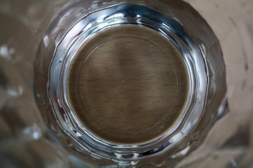 Top view of a glass of water on a wooden table