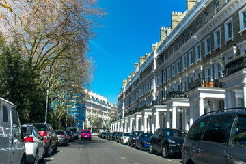 Wide view of Row of Typical old Britain Houses in London UK with cars on street