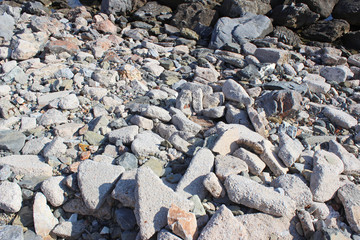 Uneven rocks and pebbles beach seaside  