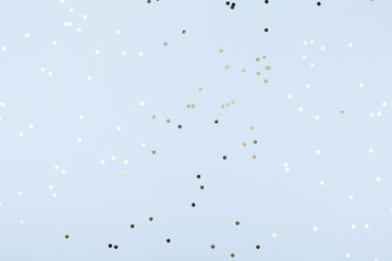 Blue background with gold and dark blue confetti. Christmas and Hanukkah, holiday concept.