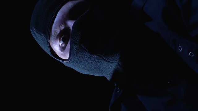 Pov of victim, criminal in balaclava closing mouth and trying to strangle person