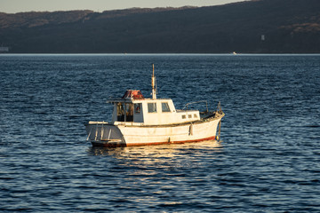 seascape with a boat on the background of the sea.