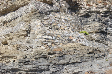 Rock surface with integrated built brick wall