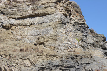 Ancient rock with integrated built brick wall