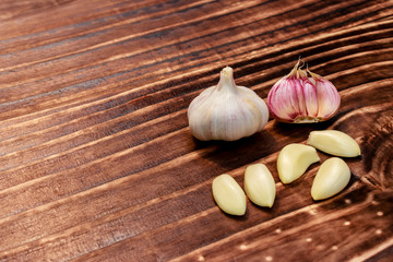 close up on garlic over dark wood, space for text