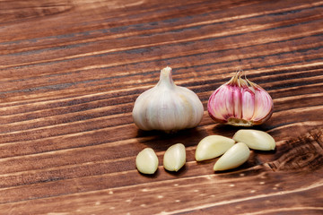 close up on garlic over dark wood, space for text