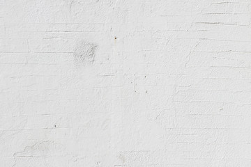 White painted uneven scratched concrete brick plaster wall traces detail fragment background