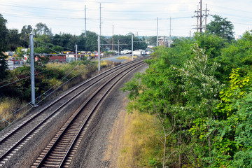 Fototapeta na wymiar Steel rail road tracks over crushed stones, disappearing in the distance (5)