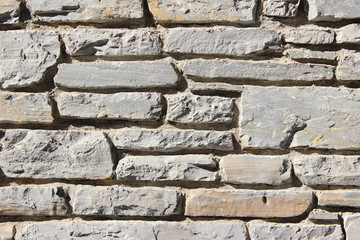 Decorative hand made stone wall detail fragment close up 