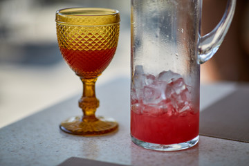 Colored glasses on the table in a summer cafe