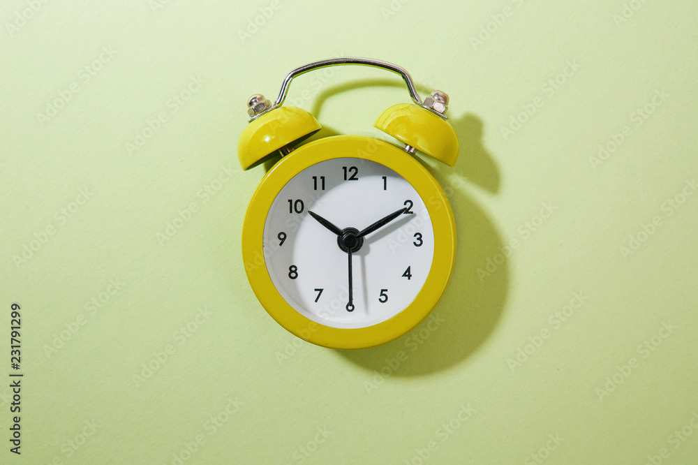 Wall mural green background and alarm clock