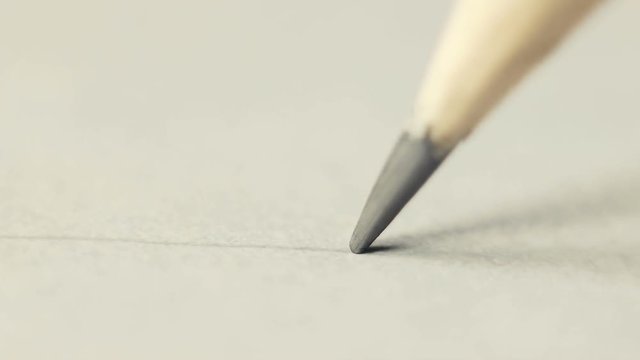 The artist draws with a pencil on paper. Or just a letter on paper