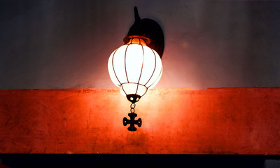 Obraz premium Vintage lantern on background texture of decorative plaster.Close up, copy space