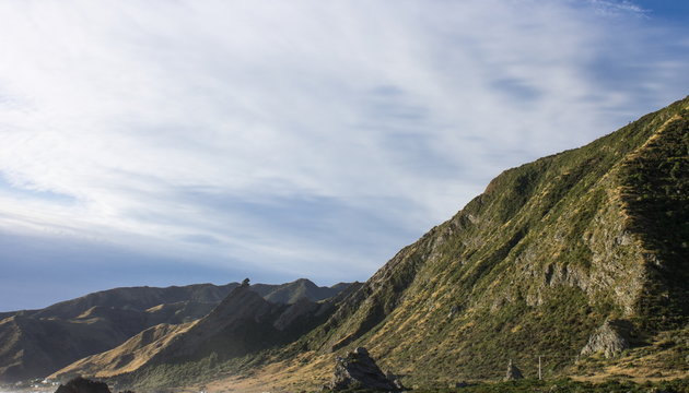 landscape image of the rocky coastal terrain of Cape Palliser, New Zealand.