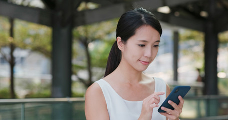 Woman watch on cellphone in city