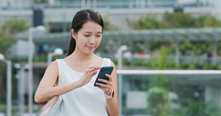 Fototapeta premium Woman use of mobile phone in city