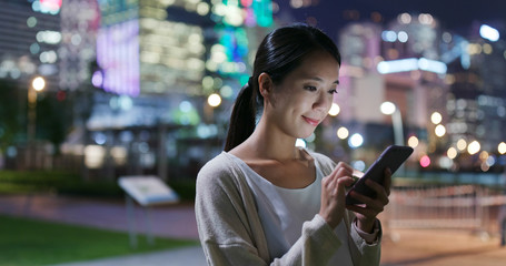 Woman use of smart phone in city