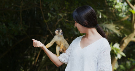 Woman tourist go to the park for visit  Squirrel Monkey