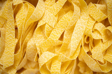 uncooked italian pappardelle pasta blur defocused