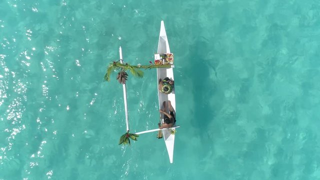 Aerial - Top view of meal delivery to overwater villa with traditional canoe