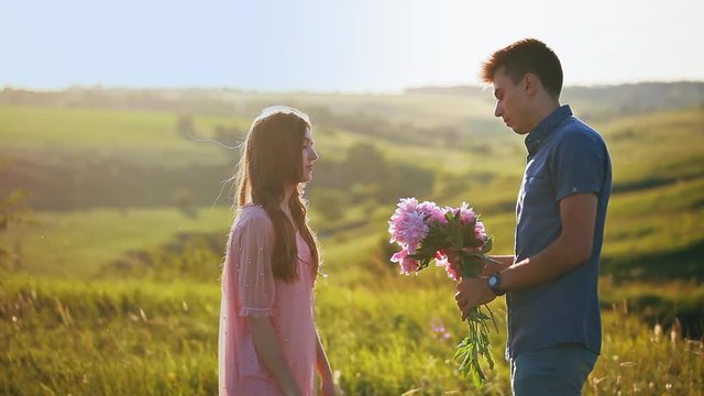 Man apologizes to the girl, the angry woman beats the guy and throws flowers at him and leaves