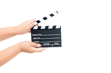 Naklejka premium Child holding movie clapper isolated on white
