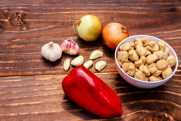 Soybeans in pieces dry with ingredients, red bell peppers, onions and garlic