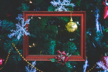 The antique red frame on the Christmas tree branches