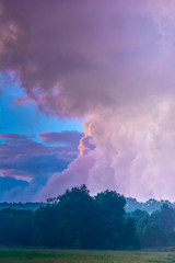 Thunderclouds against the clear evening sky. Dramatic condition in nature. Summer time in Ukraine.