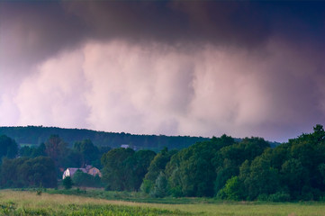Fototapeta na wymiar Thunderclouds against the clear evening sky. Dramatic condition in nature. Summer time in Ukraine.