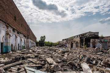 Earthquake or war aftermath or hurricane or other natural disaster, broken ruined industrial buildings, pills of concrete garbage