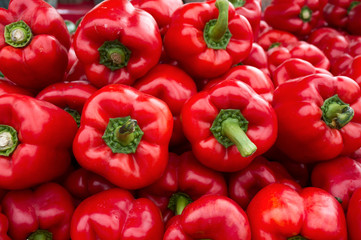 Obraz na płótnie Canvas Red, yellow, orange, and green Bell Peppers for sale at a weekend farmers market in St. Pete Beach, Florida.