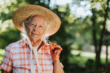 Portrait of a happy senior woman with a straw hat
