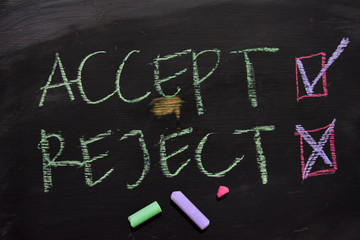 Accept or Reject written with color chalk concept on the blackboard © syahrir