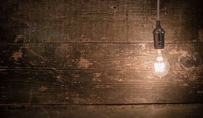 edison vintage light bulb right landscape view with barn wood background - Powered by Adobe