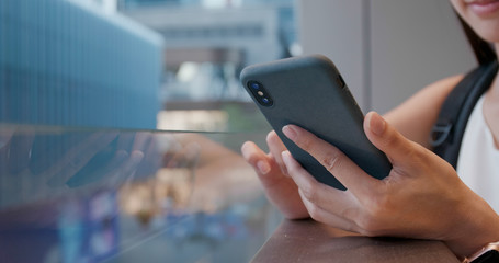 Close up of woman use of smart phone in city