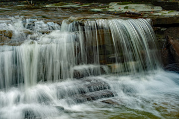 Waterfall cascading on the creek, finger lake