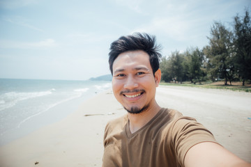 Cheerful and happy face of man selfie himself on the beach.