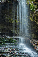 Rainbow falls cascading over the rocks in Watkins Glen state park