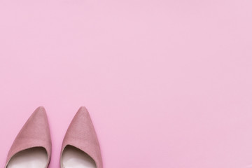 Stylish pink suede ladies shoes and copy space