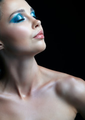 Fototapeta premium Closeup portrait of female on black background. Woman with evening beauty makeup on black background.