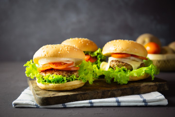 homemade hamburger with pork, onion, tomato, lettuce and cheese
