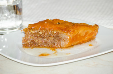 Baklava a rich, sweet dessert pastry layers of filo filled with chopped nuts and sweetened and held together with syrup or honey white background