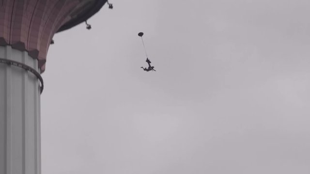 Base jumpers jumping from Menara tower in Kuala Lumpur.