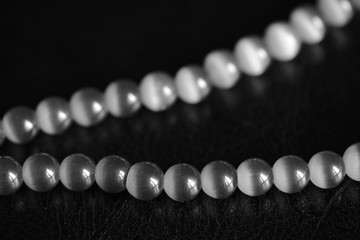 Stone necklace on a dark background close up. Black and white