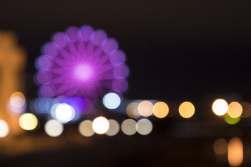 Colorful ferris wheel and city lights bokeh